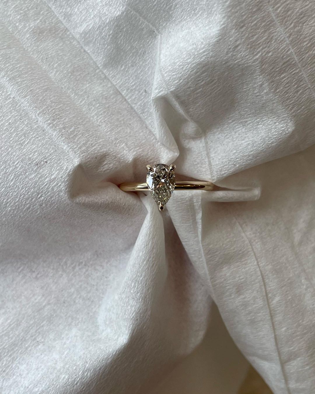 0.5ct Pear Three Claw Lab Grown Diamond Ring YouTube Amazon Facebook Weather Google Gmail Wordless WhatsApp Web Translate News blog post ring ceremony Article Life Money 2025 design Ring Ceremony Diamond Shape Diamond Ring Surat Diamond India Market Diamond Ring for Her Diamond Ring for Men Diamond Ring Women Engagement Ring Finger For Her Finger Ring Gold Ring Bluestone Ring Diamond Ring PriceΒ GoldΒ RingΒ Price diamond engagement ring with a sleek gold band, featured on a hand with a minimalist manicure.