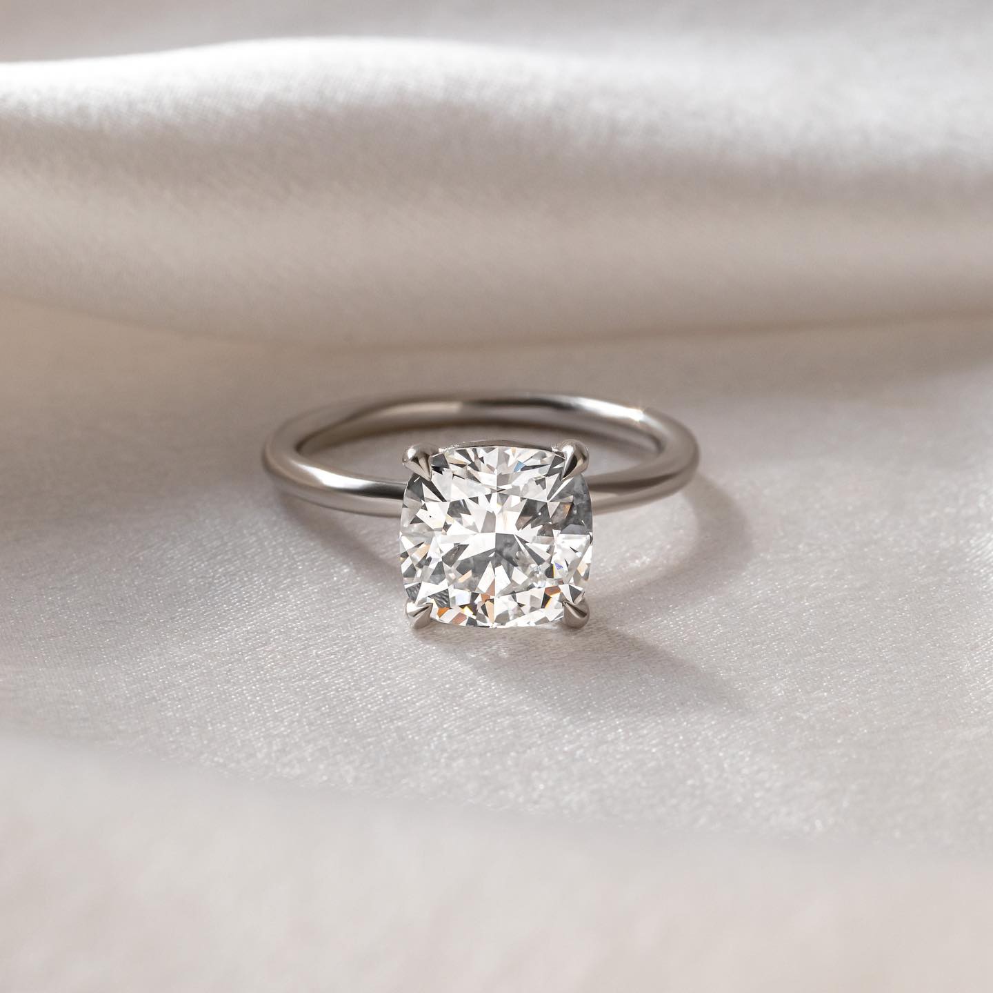 1ct Cushion Cut Lab Grown Diamond Ring Elegant close-up of a hand showcasing an engagement ring with a gold band, ideal for proposals, weddings, or luxury jewelry collections, paired with a soft, natural manicure. YouTube Amazon Facebook Weather Google Gmail Wordless WhatsApp Web Translate News blog post ring ceremony Article Life Money 2025 design Ring Ceremony Diamond Shape Diamond Ring Surat Diamond India Market Diamond Ring for Her Diamond Ring for Men Diamond Ring Women Engagement Ring Finger For Her 