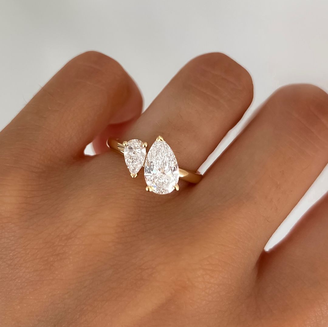 2.5ct Duet Pear Cut Lab Grown Diamond Ring The sleek gold band complements the brilliance of the diamond, creating a harmonious balance of luxury and sophistication. This ring isn't just for engagements Ring, proposals, weddings, or premium jewelry collections. YouTube Amazon Facebook Weather Google Gmail Wordless WhatsApp Web Translate News blog post ring ceremony Article Life Money 2025 design Ring Ceremony Diamond Shape Diamond Ring Surat Diamond India Market Diamond Ring for Her Diamond Ring for Men 