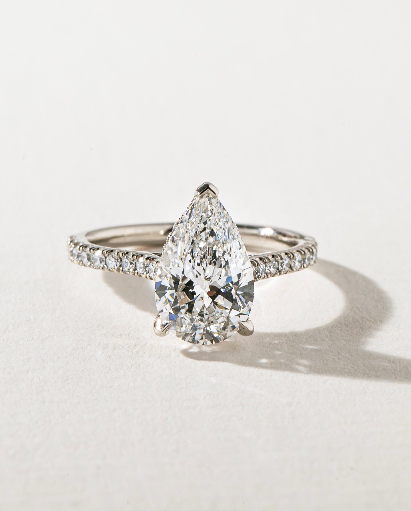 4ct Pear Cut With Pave Band Hidden Halo Lab Grown Diamond Ring Modern  diamond solitaire ring on a gold band, styled with a natural manicure. A perfect symbol of love for engagements, proposals, weddings, or premium jewelry collections. YouTube Amazon Facebook Weather Google Gmail Wordless WhatsApp Web Translate News blog post ring ceremony Article Life Money 2025 design Ring Ceremony Diamond Shape Diamond Ring Surat Diamond India Market Diamond Ring for Her Diamond Ring for Men Diamond Ring Women 