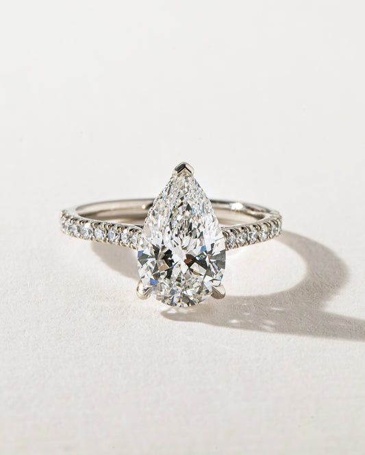4ct Pear Cut With Pave Band Hidden Halo Lab Grown Diamond Ring Modern  diamond solitaire ring on a gold band, styled with a natural manicure. A perfect symbol of love for engagements, proposals, weddings, or premium jewelry collections. YouTube Amazon Facebook Weather Google Gmail Wordless WhatsApp Web Translate News blog post ring ceremony Article Life Money 2025 design Ring Ceremony Diamond Shape Diamond Ring Surat Diamond India Market Diamond Ring for Her Diamond Ring for Men Diamond Ring Women 