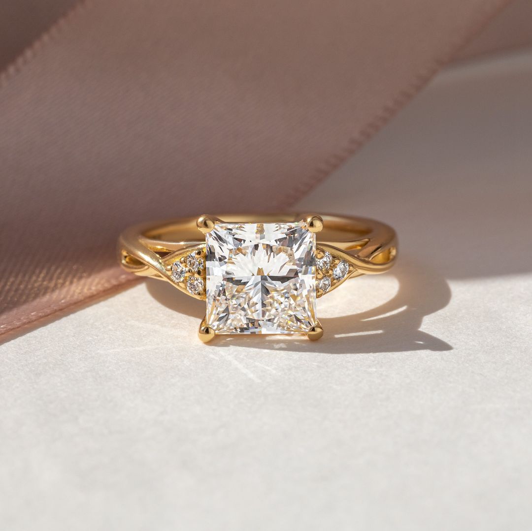 5ct Princess Cut Center & Both Side Round Cut Tiny Lab Grown Diamond Ring Close-up of a hand adorned with a sparkling  diamond ring on a sleek gold band, featuring a modern and elegant design. The ring is perfect for engagement, wedding, or luxury jewelry collections. YouTube Amazon Facebook Weather Google Gmail Wordless WhatsApp Web Translate News blog post ring ceremony Article Life Money 2025 design Ring Ceremony Diamond Shape Diamond Ring Surat Diamond India Market Diamond Ring for Her Diamond Ring for 