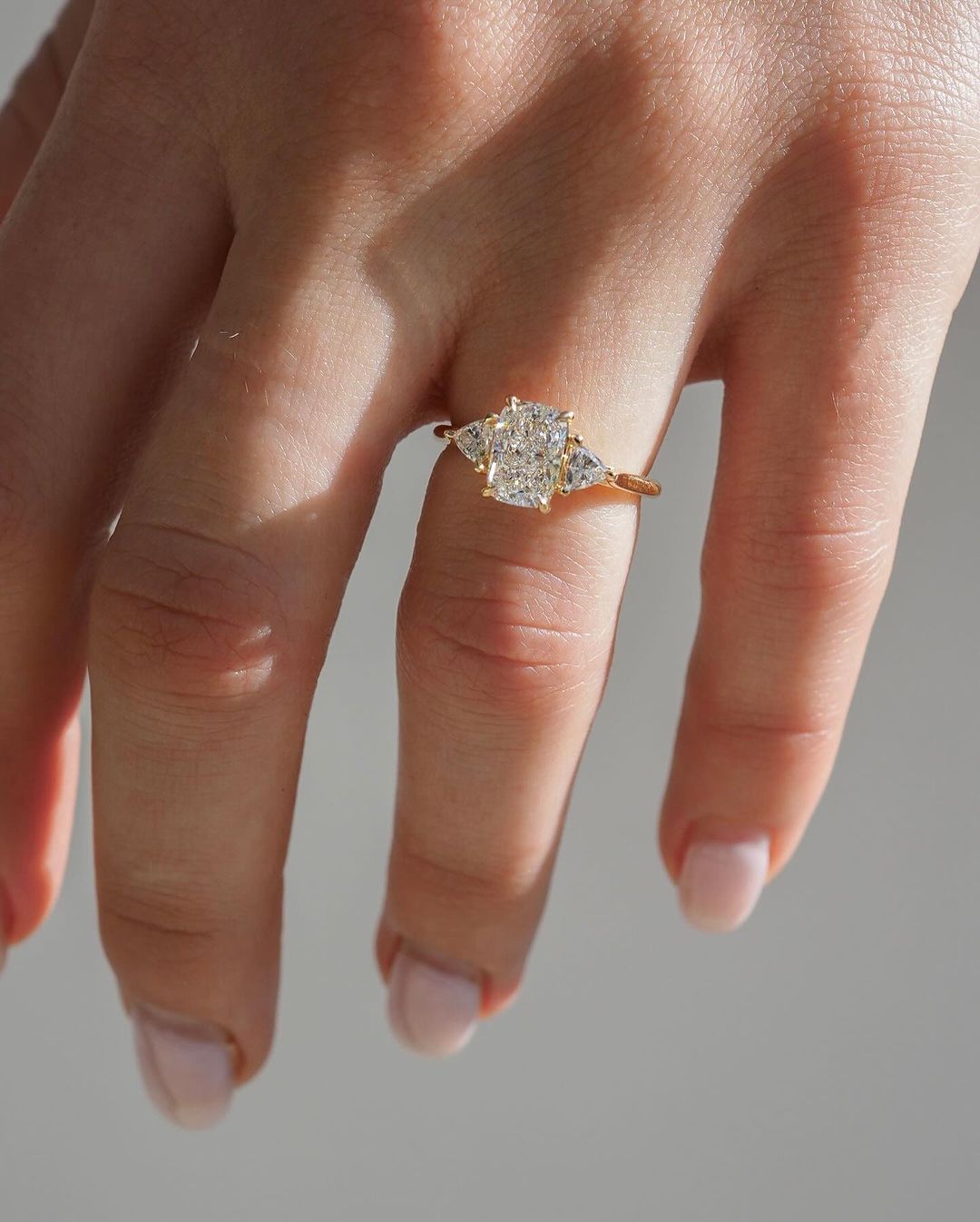 4.5ct Radiant Kite Side Lab Grown Diamond Ring Close-up of a hand adorned with a sparkling  diamond ring on a sleek gold band, featuring a modern and elegant design. The ring is perfect for engagement, wedding, or luxury jewelry collections. YouTube Amazon Facebook Weather Google Gmail Wordless WhatsApp Web Translate News blog post ring ceremony Article Life Money 2025 design Ring Ceremony Diamond Shape Diamond Ring Surat Diamond India Market Diamond Ring for Her Diamond Ring for Men Diamond Ring Women 
