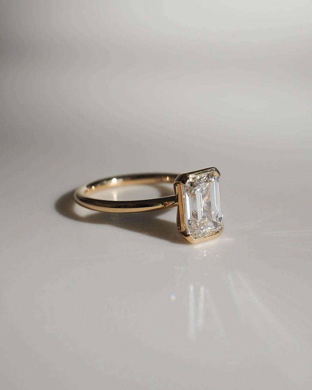 4.5ct Emerald Cut Half Bezel Lab Grown Diamond Ring Modern  diamond solitaire ring on a gold band, styled with a natural manicure. A perfect symbol of love for engagements, proposals, weddings, or premium jewelry collections. YouTube Amazon Facebook Weather Google Gmail Wordless WhatsApp Web Translate News blog post ring ceremony Article Life Money 2025 design Ring Ceremony Diamond Shape Diamond Ring Surat Diamond India Market Diamond Ring for Her Diamond Ring for Men Diamond Ring Women Engagement Ring