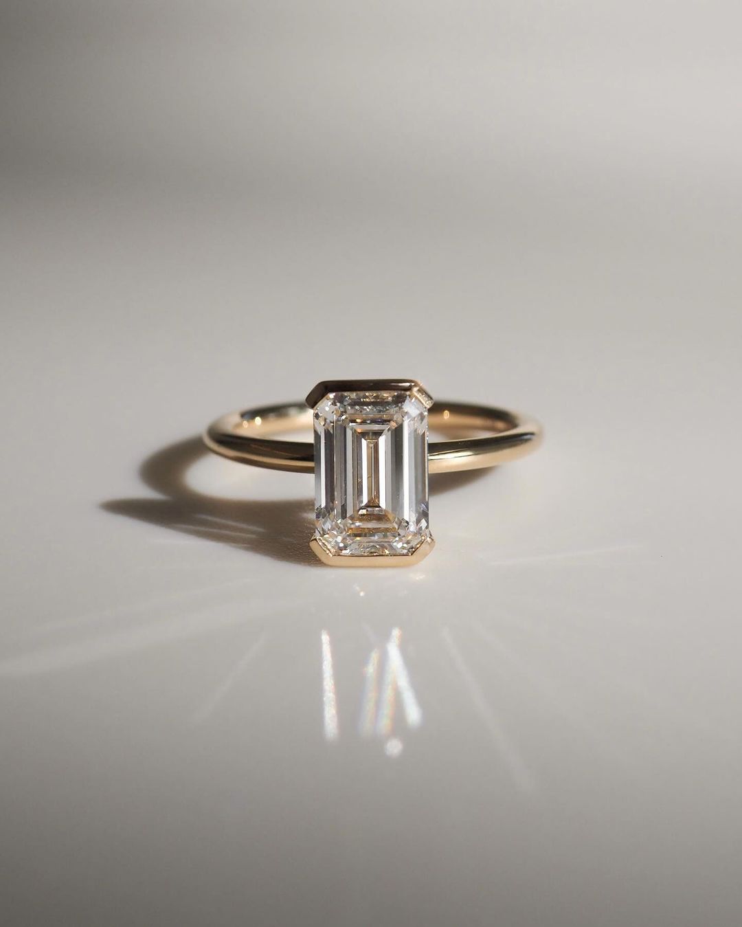 4.5ct Emerald Cut Half Bezel Lab Grown Diamond Ring Close-up of an exquisite gold-band ring featuring a diamond, ideal for engagement celebrations or luxury jewelry enthusiasts. The soft manicure enhances the refined and elegant appeal. YouTube Amazon Facebook Weather Google Gmail Wordless WhatsApp Web Translate News blog post ring ceremony Article Life Money 2025 design Ring Ceremony Diamond Shape Diamond Ring Surat Diamond India Market Diamond Ring for Her Diamond Ring for Men Diamond Ring Women 