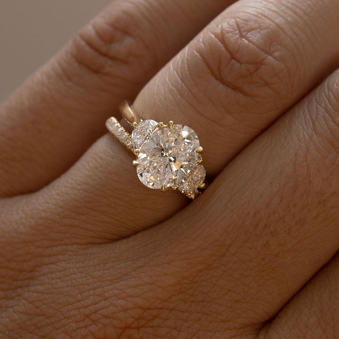 3ct Oval Cut Three Stone Lab Grown Diamond Ring Luxurious diamond engagement ring on a gold band, elegantly showcased on a well-manicured hand for wedding and proposal inspiration. YouTube Amazon Facebook Weather Google Gmail Wordless WhatsApp Web Translate News blog post ring ceremony Article Life Money 2025 design Ring Ceremony Diamond Shape Diamond Ring Surat Diamond India Market Diamond Ring for Her Diamond Ring for Men Diamond Ring Women Engagement Ring Finger For Her Finger Ring Gold Ring Bluestone  