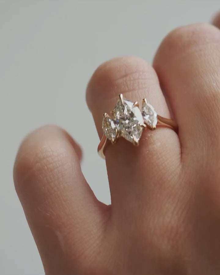 3tcw Marquise Cut Lab Grown Diamond Ring With Trio Set  The hand displays a soft, natural manicure, highlighting the diamond's brilliance and the ring's refined craftsmanship. Ideal for those seeking timeless, high-end accessories for special occasions. YouTube Amazon Facebook Weather Google Gmail Wordless WhatsApp Web Translate News blog post ring ceremony Article Life Money 2025 design Ring Ceremony Diamond Shape Diamond Ring Surat Diamond India Market Diamond Ring for Her Diamond Ring for Men Diamond 